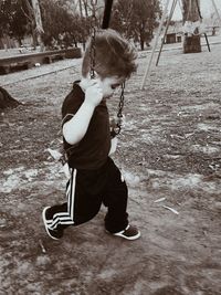 Boy playing with umbrella