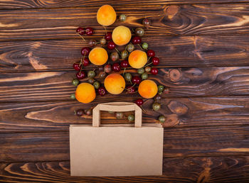 High angle view of fruits in box on wooden table