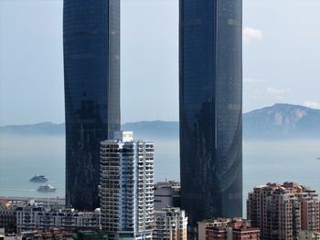 Modern buildings in city against sky