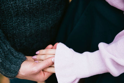 Close-up of couple holding hands