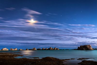 Scenic view of sea against sky at night