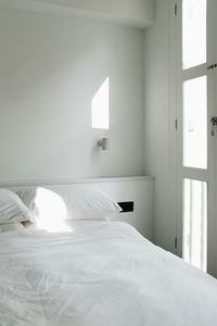 Close-up of bed by window