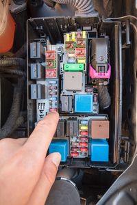 Close-up of man repairing car engine