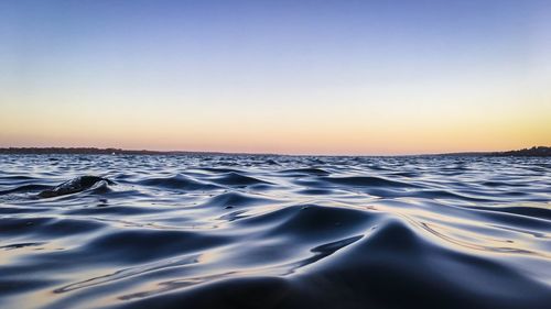 Scenic view of sea against clear sky during sunset