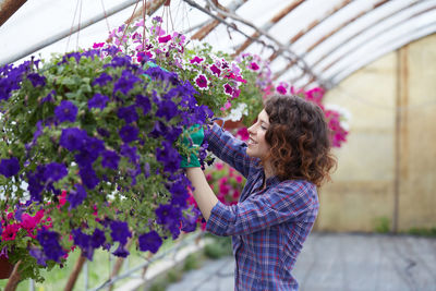 Smiling woman working in botanical garden