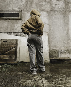 Rear view of man standing against wall