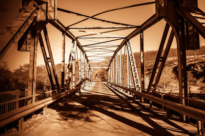 Footbridge against suspension bridge