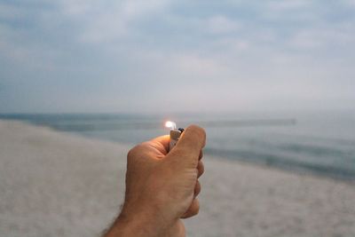 Hand holding cigarette lighter