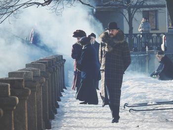 People standing in snow during winter