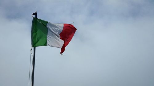 Low angle view of italian flag waving against sky