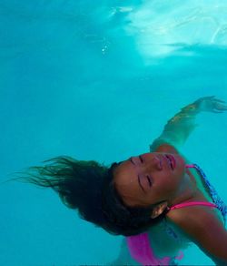 High angle view of girl swimming in pool