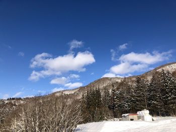 Scenic view of snowcapped mountains against blue sky