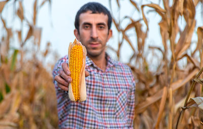 Portrait of woman holding corn