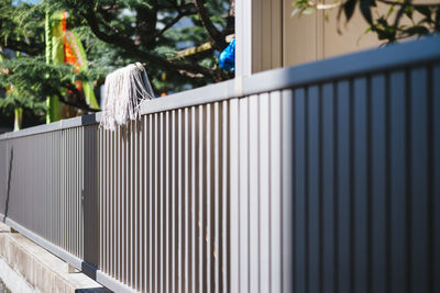 Mop over fence on sunny day