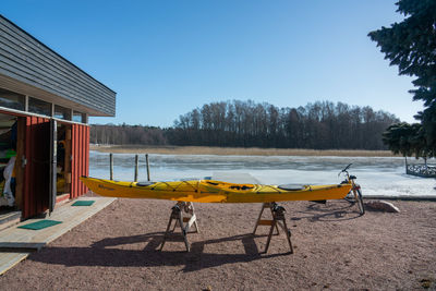 Winter in tammisaari finland. preparing the canoe for the summer with frozen water in the back