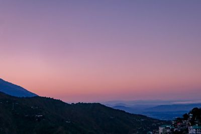 Scenic view of silhouette mountains against sky at sunset