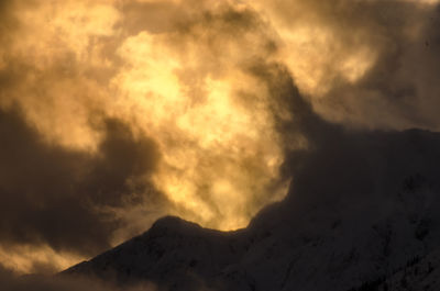 Scenic view of mountains against cloudy sky