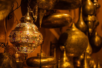 Close-up of illuminated electric lamp on table