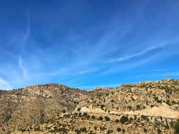 Scenic view of landscape against blue sky