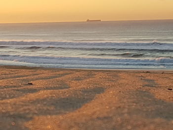 Scenic view of beach against sky during sunset