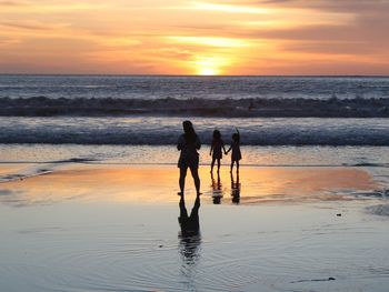 People on beach at sunset