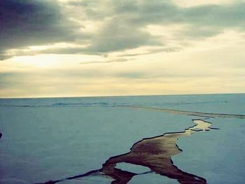 Scenic view of sea against cloudy sky