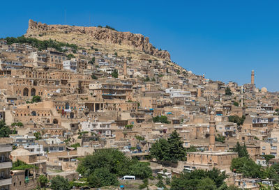 Buildings in town against clear sky