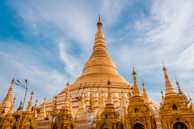 Low angle view of pagoda against cloudy sky