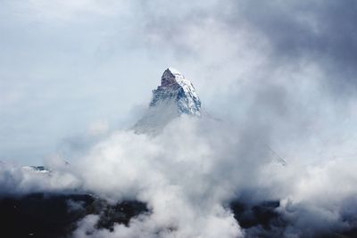 Low angle view of snowcapped mountain against sky