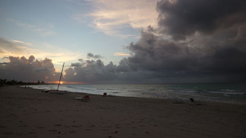 Scenic view of beach against sky during sunset