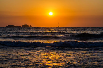 Scenic view of sea against orange sky