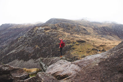 Rear view of man walking on mountain