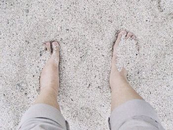 Low section of woman standing on tiled floor