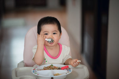 Portrait of cute boy eating food