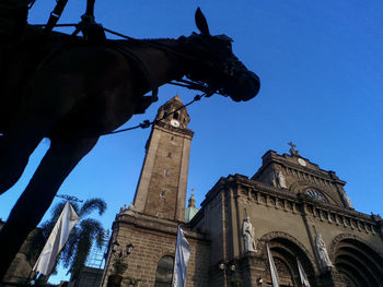 Low angle view of historic building against blue sky