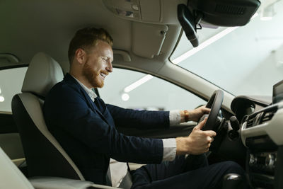 Businessman testing car in car dealership