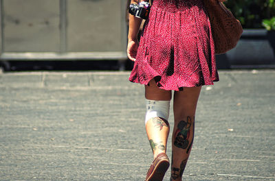 Low section of woman walking outdoors