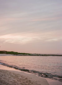 Scenic view of beach against sky during sunset