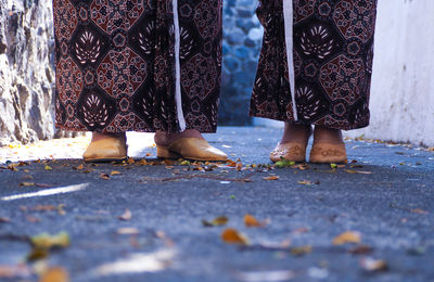 Low section of women standing at alley