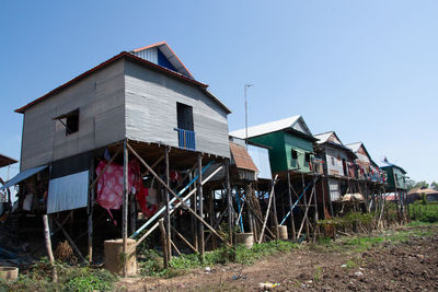 Low angle view of abandoned building against clear blue sky in cambodia