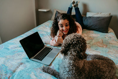 Young woman using mobile phone at home