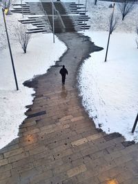 People walking on snow covered road