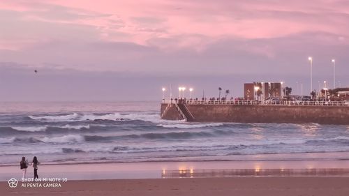 Scenic view of beach against sky during sunset