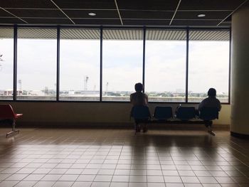 Rear view of people sitting at airport