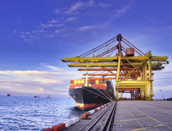 Containers are discharging from vessel by truck in port of thailand