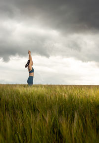 Full length of man standing on field against sky