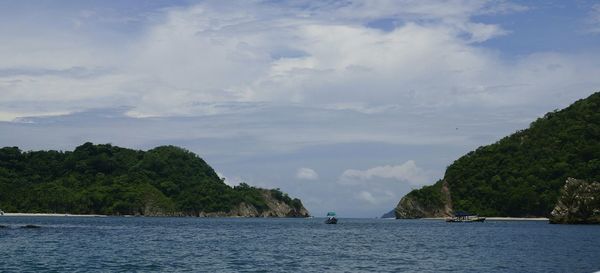 Scenic view of sea against cloudy sky