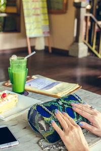 Midsection of woman having food at home