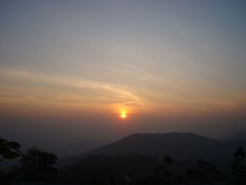 Scenic view of silhouette mountains against sky during sunset