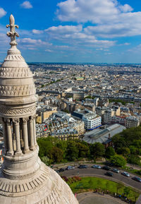 View of cityscape against cloudy sky